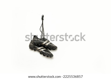 soccer spikes are hanging against white background Royalty-Free Stock Photo #2225536857
