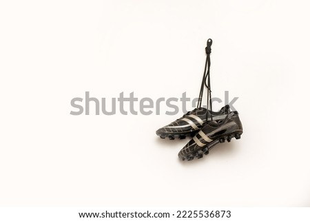 soccer spikes are hanging against white background Royalty-Free Stock Photo #2225536873