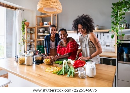 Happy beautiful hispanic south american and black women meeting indoors and having fun - Black adult females best friends spending time together, concepts about domestic life, leisure, friendship Royalty-Free Stock Photo #2225546095