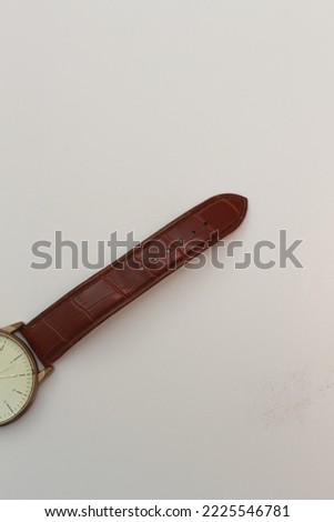 a close up of a golden watch with brown leather isolated on a white background. watch product concept photo.