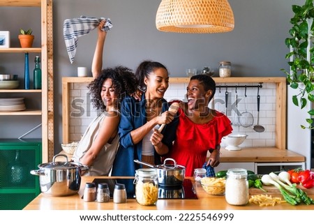 Happy beautiful hispanic south american and black women meeting indoors and having fun - Black adult females best friends spending time together, concepts about domestic life, leisure, friendship Royalty-Free Stock Photo #2225546999