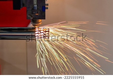 The fiber laser cutting machine cutting  machine cut the stainless steel tube. The hi-technology sheet metal manufacturing process by laser cutting machine.  Royalty-Free Stock Photo #2225555955