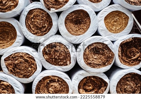 Mineral wool in rolls in the warehouse of a hardware store. Heat-insulating material for wall and ceiling insulation in a residential building and in an industrial building. Close-up