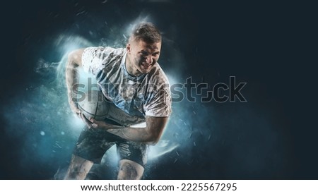 Man rugby player holds ball on smoke background. Sports banner. Horizontal copy space background Royalty-Free Stock Photo #2225567295
