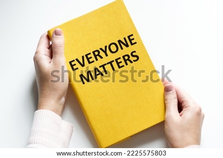 Man hands holding tablet with text Everyone Matters at workplace. Businessman working at desk with documents