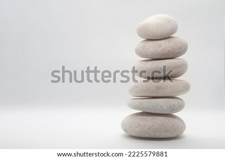 Zen stones stacking on white background with customizable space for text or ideas.