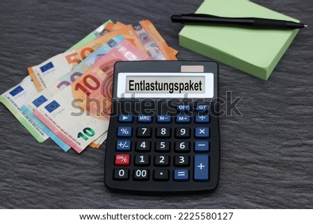 The word  Entlastungspaket  with calculator and euro banknotes.
German aid program financial relief during the energy crisis.Entlastungspaket means relief package.
 Royalty-Free Stock Photo #2225580127