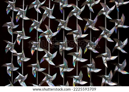 Abstract background with flickering and glittering silver metallic particles or sequins on the wall.