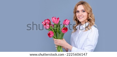 face of happy young woman with spring tulip flowers on grey background. Woman isolated face portrait, banner with mock up copy space.