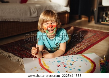 Child painting a picture at home