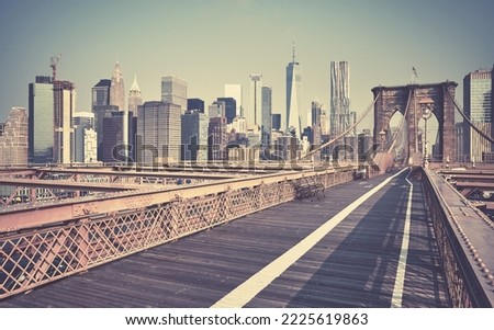Retro toned picture of New York cityscape seen from the Brooklyn Bridge, USA.
