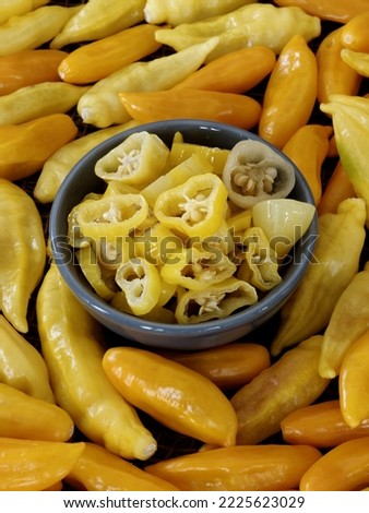 Chili pickle in a bowl. Yellow pickled chili pepper vegetable slices.