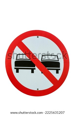 Forbidden to overtake: road sign closeup. On white background, to cut
