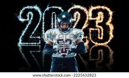 American football player black background with fire. Sports template for calendar design on 2023 year.