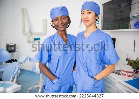 Two female doctors in the dental office, colleagues of different ethnicities. Royalty-Free Stock Photo #2225644327