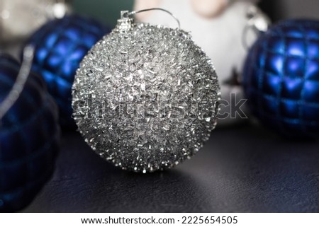 Blue and silver shiny ornaments Christmas balls on black background