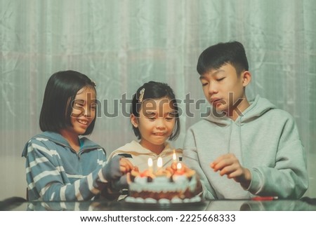 Cake happy birth day concept, happy family people on birth day night time, happy kids smile and holding flowerfire or firework for celebration, cute child girl and boy joyful happiness for eating cake