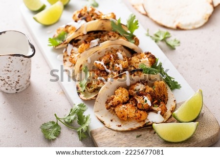 Spicy roasted cauliflower tacos with cilantro and mexican crema