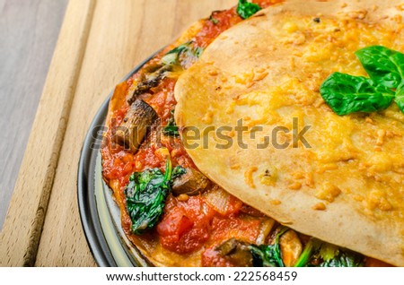 Vegetarian tortilla and bolognese sauce and spinach, baked with cheddar cheese