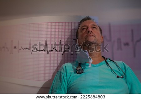 a doctor staring into the sky overlaid with an electrocardiogram concept of cardiovascular disorder or cardiovascular checks