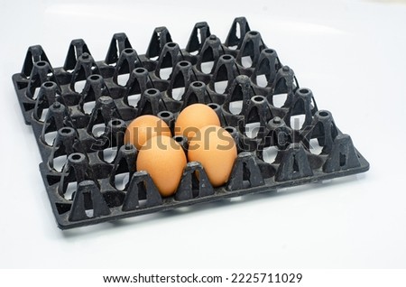 Close-Up Of Eggs In Cartoon On White Background