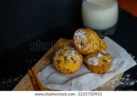 Sponge cake served on a wooden cutting board. Nutritious snack, dessert or breakfast. Black background. Close-up of food.