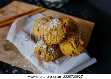 Sponge cake served on a wooden cutting board. Nutritious snack, dessert or breakfast. Black background. Close-up of food.