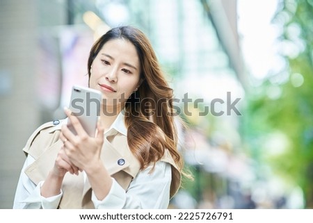 Woman holding a smartphone outdoors