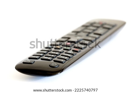Black tv remote control front view with blur gradient on white background