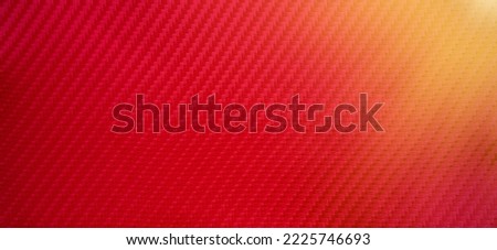 Rectangular texture of red carbon fiber.Photo of a carbon film background for tuning a sports car with illumination.