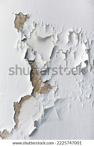 Paint used for painting non-standard house walls causes the wall paint to peel off. Royalty-Free Stock Photo #2225747001