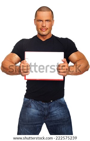 Muscular man holds a sign with white paper, on the paper you can write some text