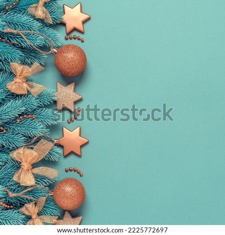Christmas border with decorative spruce branches and golden ornaments on a turquoise pastel background. Top view, flat lay, square image. New Year's composition.