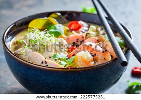Tasty Malaysian Soup made of coconut milk and shrimps. Classic Malaysian soup with vegetables and meat. Royalty-Free Stock Photo #2225775231