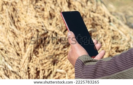 mobile phone in hand grain background