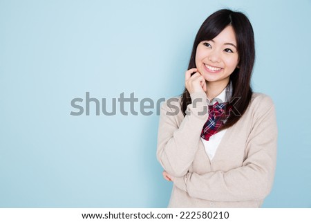 young asian student isolated on blue background