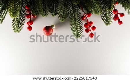 christmas layout with christmas tree branches,red berries and white background. copy space. top view. flat lay