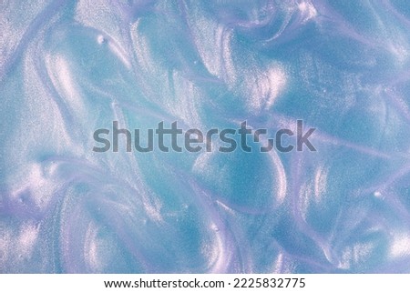 Shimmering glowing holographic liquid blue purple cosmetic texture spray  Royalty-Free Stock Photo #2225832775