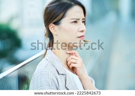 Young woman feeling unwell outdoors Royalty-Free Stock Photo #2225842673