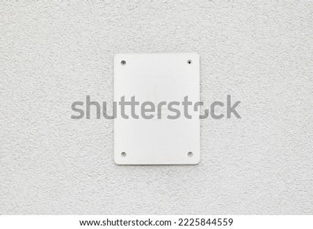 Ground cable cover plate, symbol on the side wall of a building, sign closeup, nobody, no people. Electricity, electrical symbols, ground wire covering, home circuit wiring planning simple concept