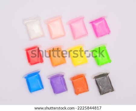 Vivid air plasticine, a soft colorful air mass for children's art that dries after modeling isolated on white background. Modeling clay for kids education and development. Royalty-Free Stock Photo #2225844817