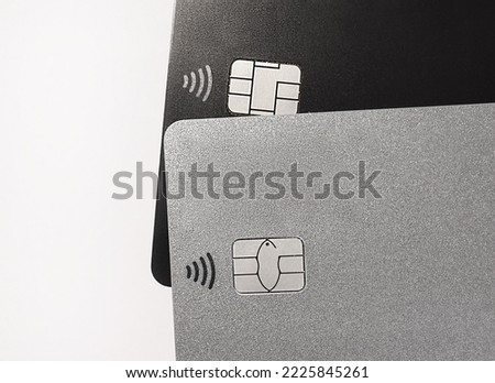 Bank cards with RFID chips. Radio Frequency IDentification tags. Contactless payment technology. RFID tag chip closeup. No name black and platinum bank card. Banking products and services. Radio waves Royalty-Free Stock Photo #2225845261