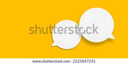 White paper in speech bubble shape set against yellow background.Communication bubbles. Royalty-Free Stock Photo #2225847235