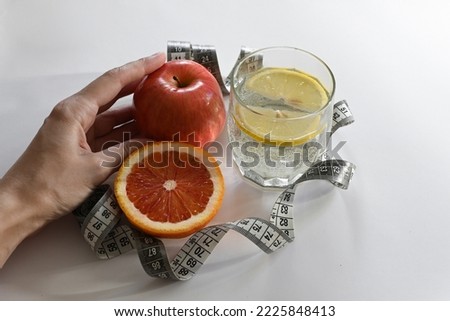 Top view of fresh fruits and vegetables next to phonendoscope on light blue wooden background. Concept of health care. Balanced diet. Copy space