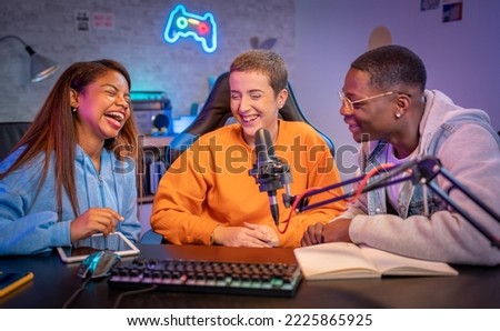 Young happy multiracial people performing at radio program making podcast recording for online show