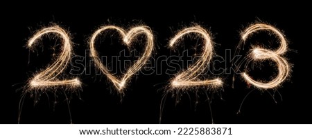 2023 New Year Sparkler Light drawn in numbers and heart shape for happy new year at night time to celebrate special holiday occasion, Christmas party, diwali, independent day or important event