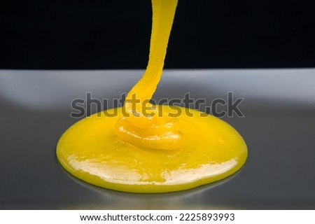 Fresh viscous floral honey flows onto the plate. vitamin organic food Royalty-Free Stock Photo #2225893993