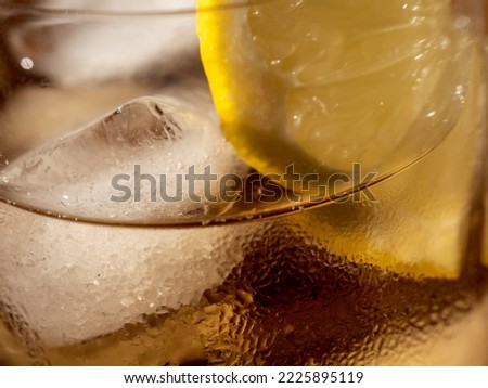 Iced tea in a glass with ice cubes. Cold tea with ice. Close up.