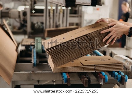 production of corrugated cardboard conveyor Royalty-Free Stock Photo #2225919255