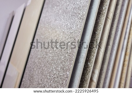 Exposition of ceramics in a showroom new tiling option for floors and walls for home building improvement works. Royalty-Free Stock Photo #2225926495